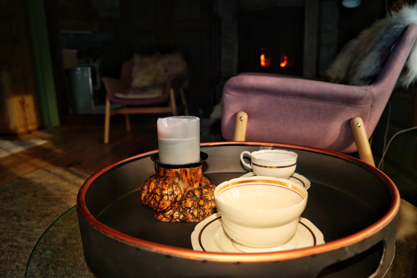 Armchair by the fireplace with a cup of coffee